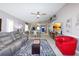 Open-concept living room with tile floors, modern ceiling fan, and access to the dining and kitchen areas at 1115 San Cristobal Ave, Punta Gorda, FL 33983