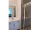 Modern bathroom featuring a double vanity, a large mirror, and a glass-enclosed shower for a spa-like experience at 12390 Wellen Golf St # 202, Venice, FL 34293