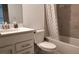 Traditional bathroom featuring a tub with shower, toilet, large vanity, and neutral tile design at 12390 Wellen Golf St # 202, Venice, FL 34293