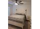 Cozy bedroom showcasing a bed, ceiling fan, carpet flooring, and two nightstands providing a warm and inviting atmosphere at 12390 Wellen Golf St # 202, Venice, FL 34293