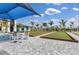 Outdoor bocce ball courts in a community with tables, chairs, and beautiful landscaping at 12390 Wellen Golf St # 202, Venice, FL 34293