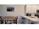 Kitchen and dining area featuring white cabinets, an island, and stainless steel appliances at 12390 Wellen Golf St # 202, Venice, FL 34293