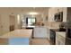 Open concept kitchen with an island, stainless steel appliances and an adjoining living area at 12390 Wellen Golf St # 202, Venice, FL 34293