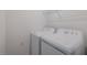 Functional laundry room equipped with a washer, dryer, and additional storage space for added convenience at 12390 Wellen Golf St # 202, Venice, FL 34293