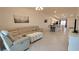 Spacious living room with a view to the kitchen and dining, featuring neutral tones and a comfortable layout at 12390 Wellen Golf St # 202, Venice, FL 34293