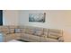 Open-concept living room showcasing a large sectional sofa and an entertainment area for relaxation and enjoyment at 12390 Wellen Golf St # 202, Venice, FL 34293