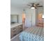 Serene bedroom featuring neutral tones, a ceiling fan, and an ensuite bathroom for added privacy and comfort at 12390 Wellen Golf St # 202, Venice, FL 34293