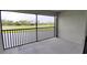 Private screened patio boasting views of golf course, providing a serene outdoor retreat at 12390 Wellen Golf St # 202, Venice, FL 34293