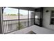 Screened patio with a view of the complex and railings at 12390 Wellen Golf St # 202, Venice, FL 34293