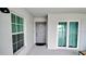 Condominium patio with a sliding glass door and large window at 12390 Wellen Golf St # 202, Venice, FL 34293