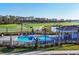Overhead view of resort-style pool, lounge area, and lush golf course in a sunny community at 12390 Wellen Golf St # 202, Venice, FL 34293