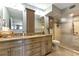 Bathroom featuring a walk-in shower, dual sinks, and light wood cabinetry at 1250 W Marion Ave # 333, Punta Gorda, FL 33950