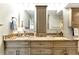 Bathroom featuring dual sinks, mosaic backsplash and light wood cabinetry at 1250 W Marion Ave # 333, Punta Gorda, FL 33950