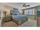 Comfortable bedroom featuring a ceiling fan, natural light from the windows, and soothing decor at 1250 W Marion Ave # 333, Punta Gorda, FL 33950