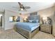 Comfortable bedroom featuring a ceiling fan, natural light from the windows, and soothing decor at 1250 W Marion Ave # 333, Punta Gorda, FL 33950