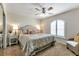 Relaxing bedroom with neutral tones, plush carpeting, ceiling fan, and arched window at 1250 W Marion Ave # 333, Punta Gorda, FL 33950