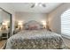 Relaxing bedroom with neutral tones, plush carpeting, ceiling fan, and window at 1250 W Marion Ave # 333, Punta Gorda, FL 33950