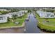 Aerial view of a canal with private boat docks between waterfront condos and lush greenery at 1250 W Marion Ave # 333, Punta Gorda, FL 33950