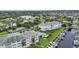 Aerial view of condos with tennis court, pool, boat docks, and manicured lawns at 1250 W Marion Ave # 333, Punta Gorda, FL 33950