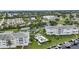 Aerial view of condos, tennis courts, a community pool, and a boat dock at 1250 W Marion Ave # 333, Punta Gorda, FL 33950