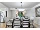 Well-lit dining room with an oval wooden table and upholstered chairs with nailhead trim at 1250 W Marion Ave # 333, Punta Gorda, FL 33950