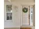 Charming condo entrance with a decorative wreath, a window for natural light, and an inviting neutral color scheme at 1250 W Marion Ave # 333, Punta Gorda, FL 33950