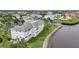 Exterior view of waterfront condo featuring well-maintained lawn and a rock seawall at 1250 W Marion Ave # 333, Punta Gorda, FL 33950