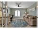 Inviting home office with a comfortable sofa, desk, and a large round rug creating a productive and stylish workspace at 1250 W Marion Ave # 333, Punta Gorda, FL 33950