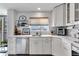 A bright modern kitchen with white cabinets, stainless steel appliances, and a window that offers plenty of natural light at 1250 W Marion Ave # 333, Punta Gorda, FL 33950