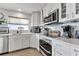 Contemporary kitchen featuring white cabinets, stainless steel appliances, modern fixtures, and lots of counter space at 1250 W Marion Ave # 333, Punta Gorda, FL 33950