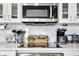 Bright kitchen with a stainless steel microwave, coffee maker and electric range on the white countertop at 1250 W Marion Ave # 333, Punta Gorda, FL 33950