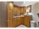 Organized pantry area with ample storage, featuring wood cabinets, a countertop, and essential kitchen appliances at 1250 W Marion Ave # 333, Punta Gorda, FL 33950