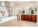 Well-appointed bathroom featuring a soaking tub, glass-enclosed shower, and double vanity at 13139 Preserve Ct, Port Charlotte, FL 33953
