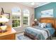 Inviting bedroom showcasing natural light from the three windows, complemented by stylish decor at 13139 Preserve Ct, Port Charlotte, FL 33953