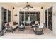 Inviting covered patio with comfortable wicker furniture and sliding glass doors at 13139 Preserve Ct, Port Charlotte, FL 33953