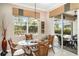 Cozy dining area with patio access showcasing views of the private pool and patio at 13139 Preserve Ct, Port Charlotte, FL 33953
