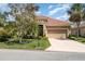Charming home with manicured landscaping, including mature trees and a well-kept lawn at 13139 Preserve Ct, Port Charlotte, FL 33953