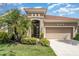 Inviting home with a two-car garage, elegant entryway, and well-maintained front yard at 13139 Preserve Ct, Port Charlotte, FL 33953