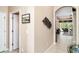 Hallway leading to the living area featuring tiled floors and arched entryway at 13139 Preserve Ct, Port Charlotte, FL 33953