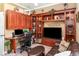 Home office with custom built-in shelves, a desk area, and a comfortable sitting area at 13139 Preserve Ct, Port Charlotte, FL 33953