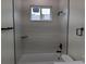Modern bathroom featuring bathtub and shower combination with sleek tiling at 136 Sequoyah Dr, Port Charlotte, FL 33954