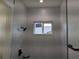 Modern bathroom featuring bright gray tiling and a modern showerhead at 136 Sequoyah Dr, Port Charlotte, FL 33954