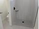 Modern bathroom featuring grey shower tiling, modern fixtures, and mosaic shower floor at 136 Sequoyah Dr, Port Charlotte, FL 33954