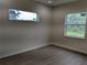Bedroom with neutral walls and two windows providing natural light at 136 Sequoyah Dr, Port Charlotte, FL 33954
