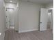 A bright bedroom with neutral walls, luxury vinyl flooring, and minimalist design at 136 Sequoyah Dr, Port Charlotte, FL 33954