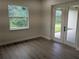 Bedroom with neutral walls, window, and French doors opening to the outside at 136 Sequoyah Dr, Port Charlotte, FL 33954