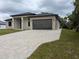 Contemporary exterior with a paved driveway leading to an attached two-car garage at 136 Sequoyah Dr, Port Charlotte, FL 33954