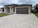 Front exterior of the house showcasing a wide driveway and large garage door at 136 Sequoyah Dr, Port Charlotte, FL 33954