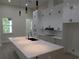 Spacious kitchen with white cabinets, granite countertops, large island, and stainless steel appliances at 136 Sequoyah Dr, Port Charlotte, FL 33954