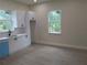 Bright kitchen featuring white cabinets, light countertops, stainless steel appliances and views to the outdoors at 136 Sequoyah Dr, Port Charlotte, FL 33954